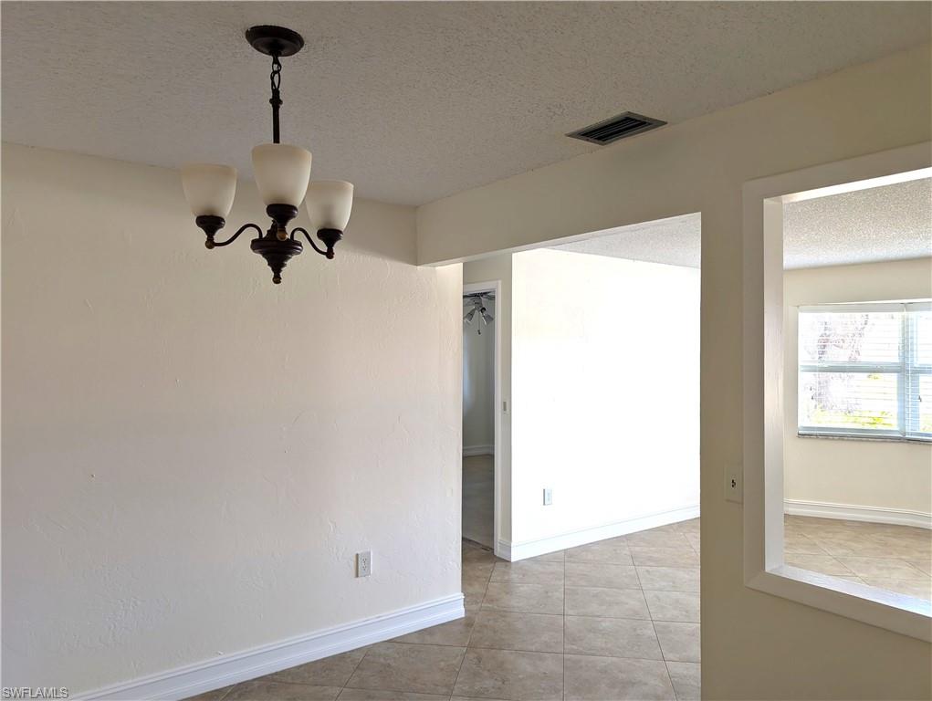 1630 South Fountainhead Road Fort Myers, FL 33919 - Photo 5 of 29 Dining area with light tile-patterned floors, with an open look into the living room