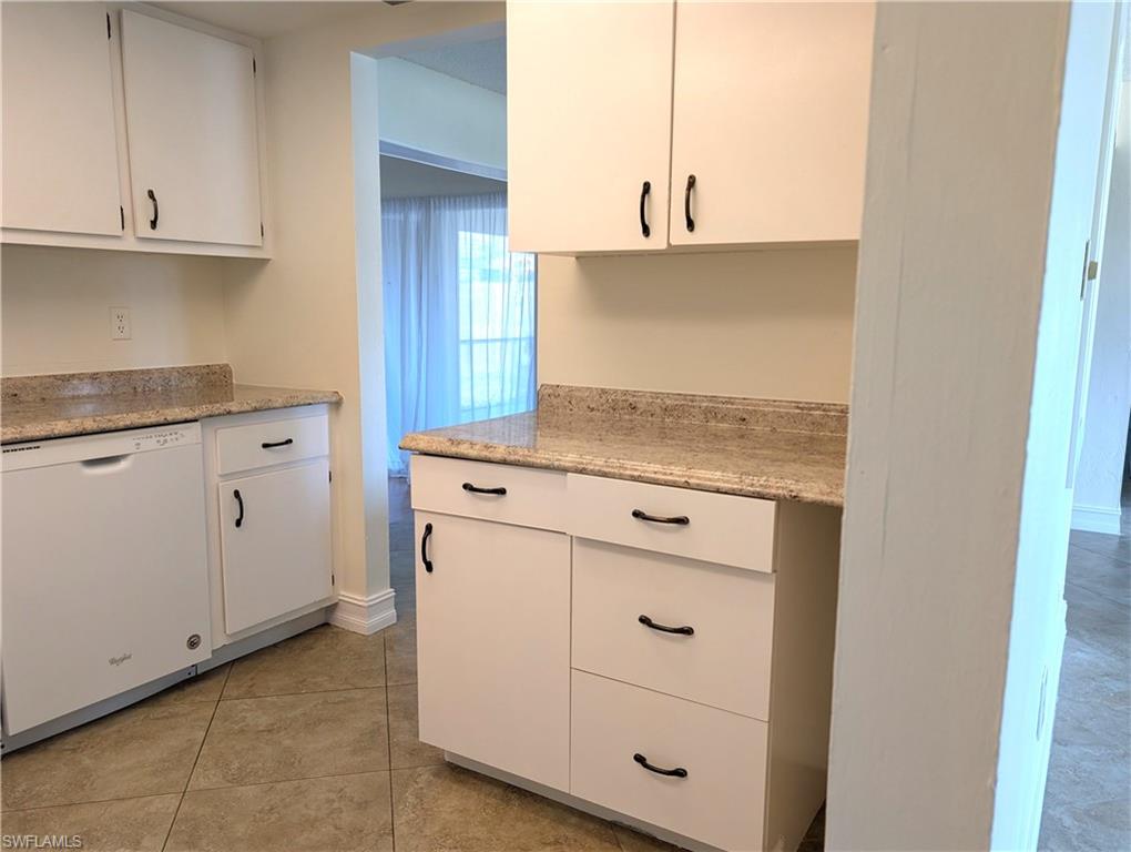 1630 South Fountainhead Road Fort Myers, FL 33919 - Photo 7 of 29 Kitchen featuring light tile patterned floors, white cabinetry, and dishwasher