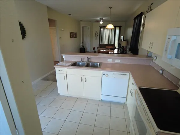a bathroom with a granite countertop sink a toilet and a mirror
