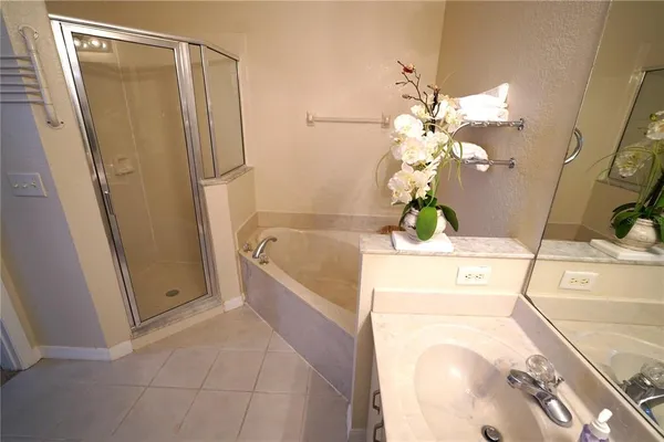 a bathroom with a tub sink and mirror