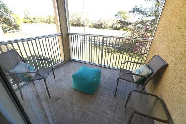 a view of a chair with a table and chairs