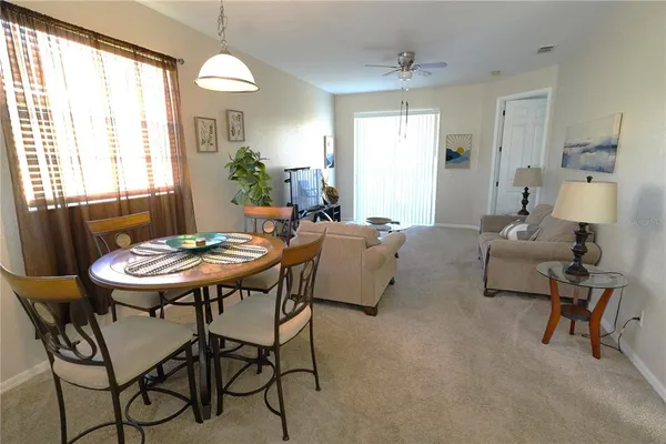 a view of a dining room with furniture and window