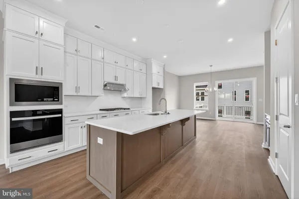 a kitchen with a stove a sink and a refrigerator