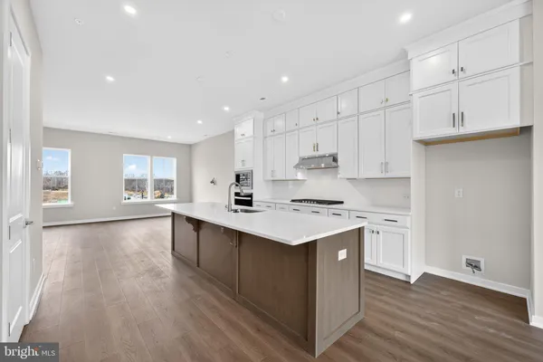 a kitchen with stainless steel appliances sink stove and cabinets
