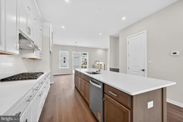 a kitchen with stainless steel appliances a sink and stove