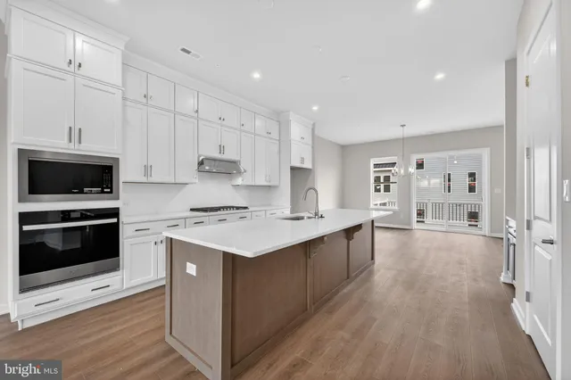 a kitchen with stainless steel appliances a sink and stove
