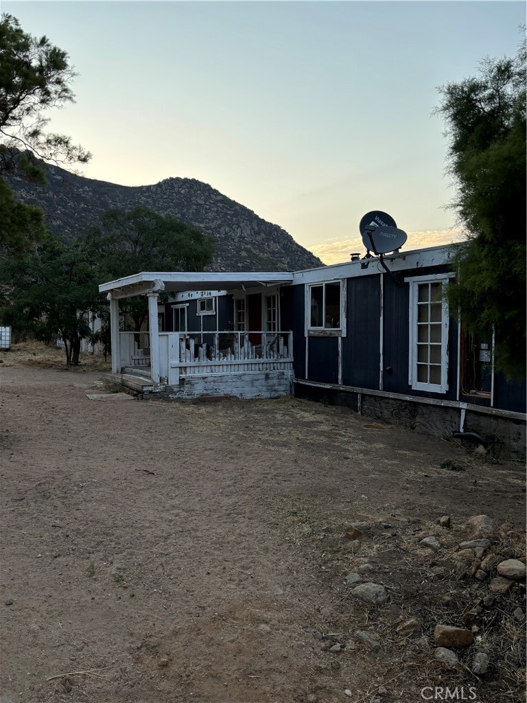 45475 Chapman Road Anza, CA 92539 - Photo 3 of 6 a front view of a house with a yard and potted plants