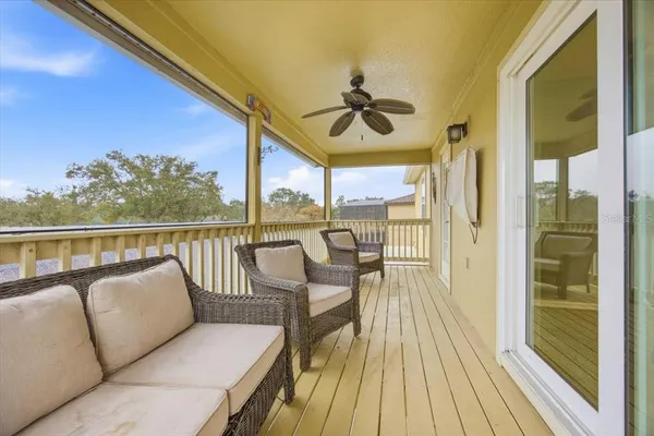 a balcony with wooden floor and outdoor space