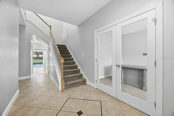 a view of a hallway to rooms and stairs