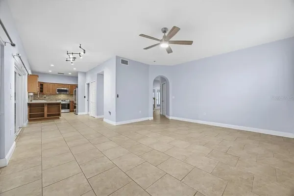 a view of a livingroom with a ceiling fan and window