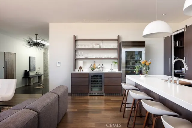 a living room with furniture a chandelier and a dining table