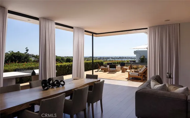 a room with furniture water view and large windows