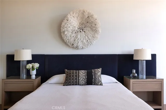 a bed sitting in a bedroom next to a window