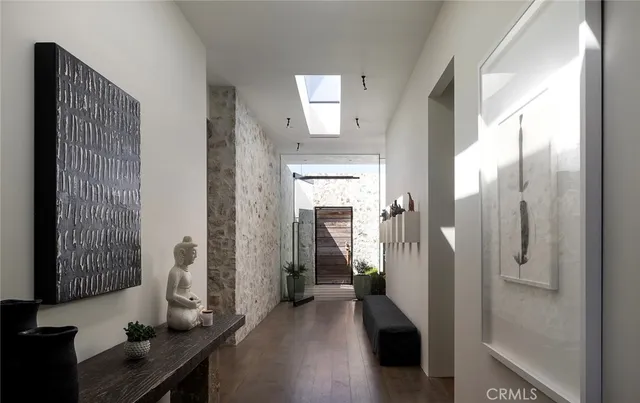a view of a hallway with wooden floor and windows