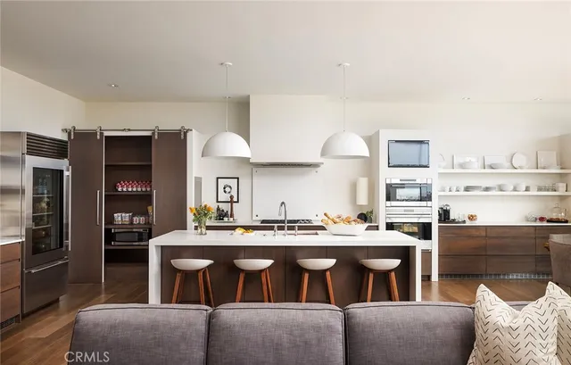 a living room with stainless steel appliances kitchen island granite countertop furniture and a kitchen view