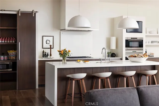 a kitchen with stainless steel appliances a sink and a refrigerator