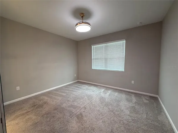 an empty room with a empty space and windows