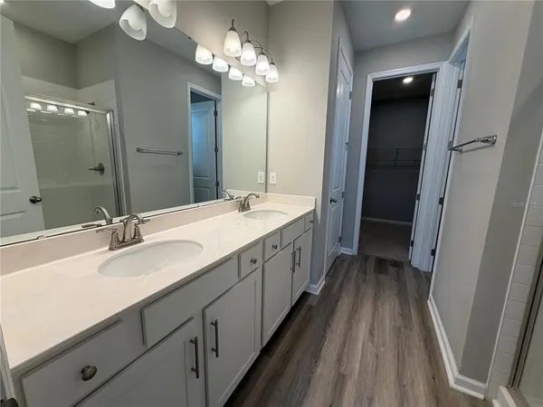 a spacious bathroom with a double vanity sink and a mirror