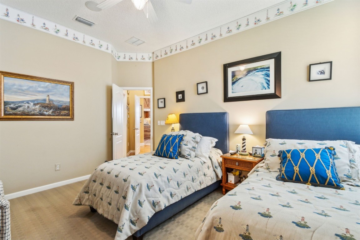 3045 Riverside Drive Fernandina Beach, FL 32034 - Photo 18 of 35 a bedroom with two beds and painting on the wall