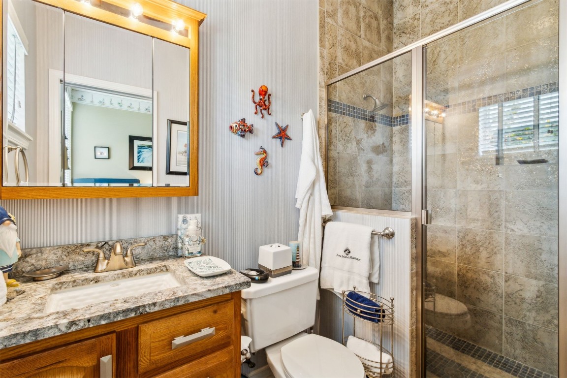 3045 Riverside Drive Fernandina Beach, FL 32034 - Photo 19 of 35 a bathroom with a granite countertop sink toilet and shower