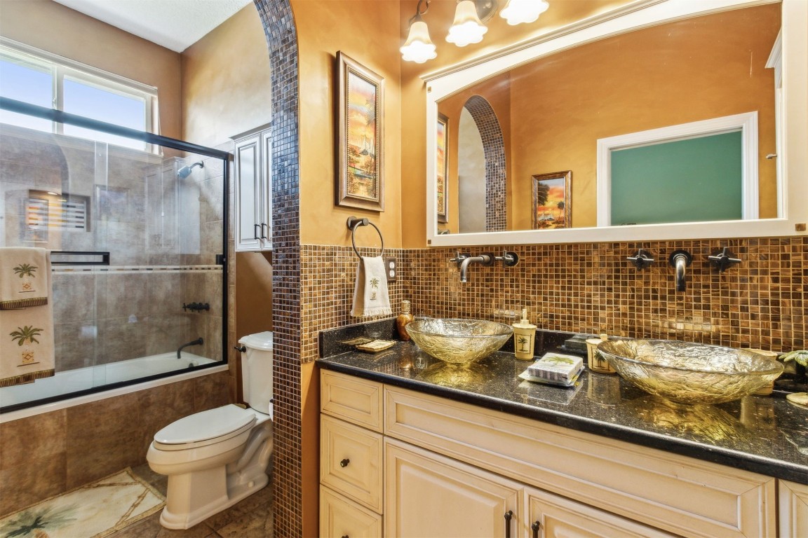 3045 Riverside Drive Fernandina Beach, FL 32034 - Photo 21 of 35 a bathroom with a sink a toilet and shower