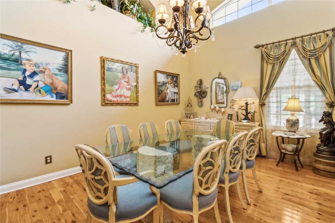 3045 Riverside Drive Fernandina Beach, FL 32034 - Photo 6 of 35 a view of a dining room with furniture wooden floor and a chandelier