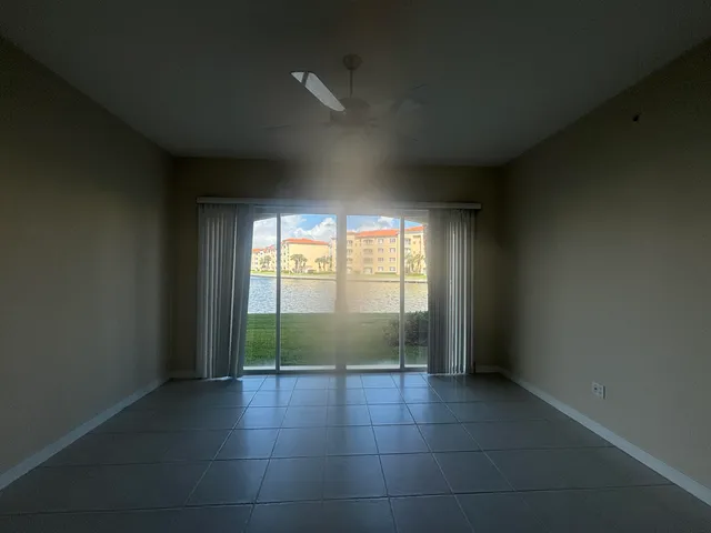 an empty room with large windows