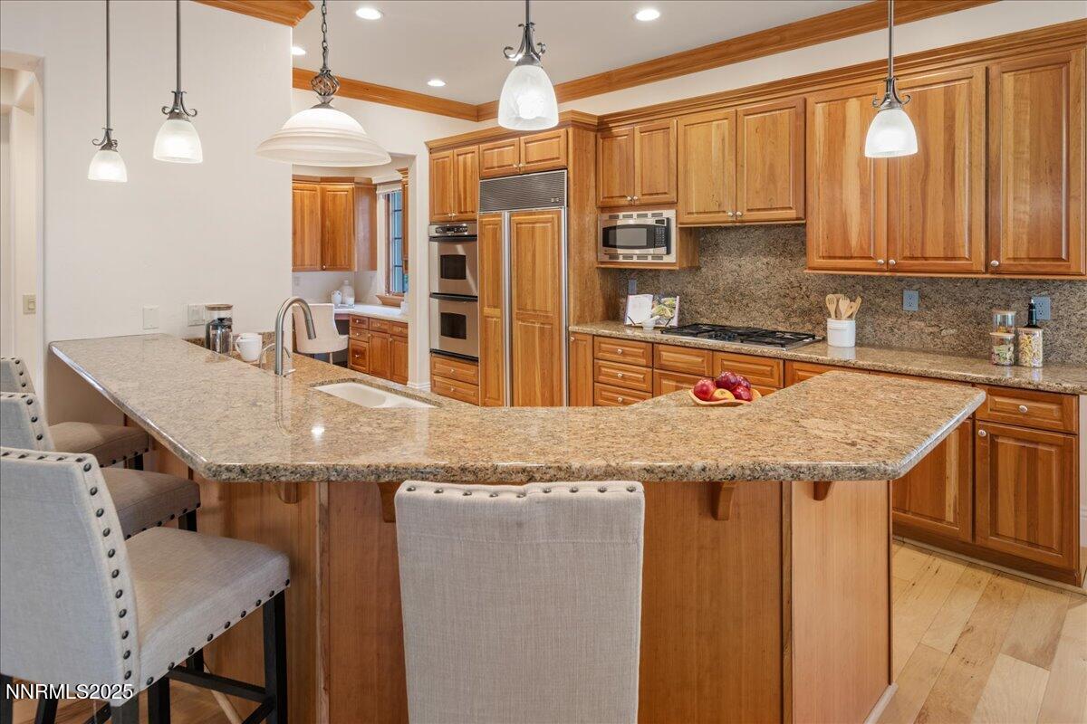 6410 Zermatt Court Reno, NV 89511 - Photo 11 of 52 a kitchen with stainless steel appliances granite countertop a sink and a refrigerator