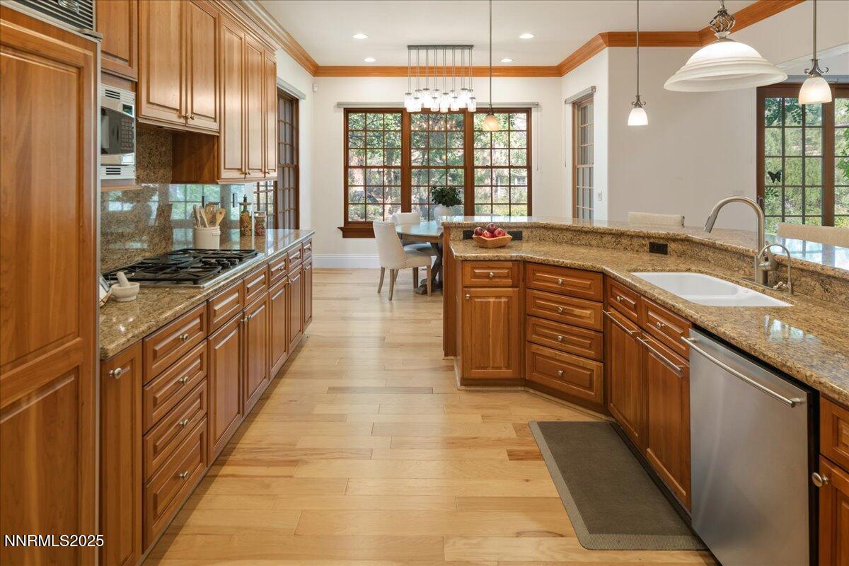 6410 Zermatt Court Reno, NV 89511 - Photo 13 of 52 a large kitchen with stainless steel appliances granite countertop a large counter top a stove and a refrigerator