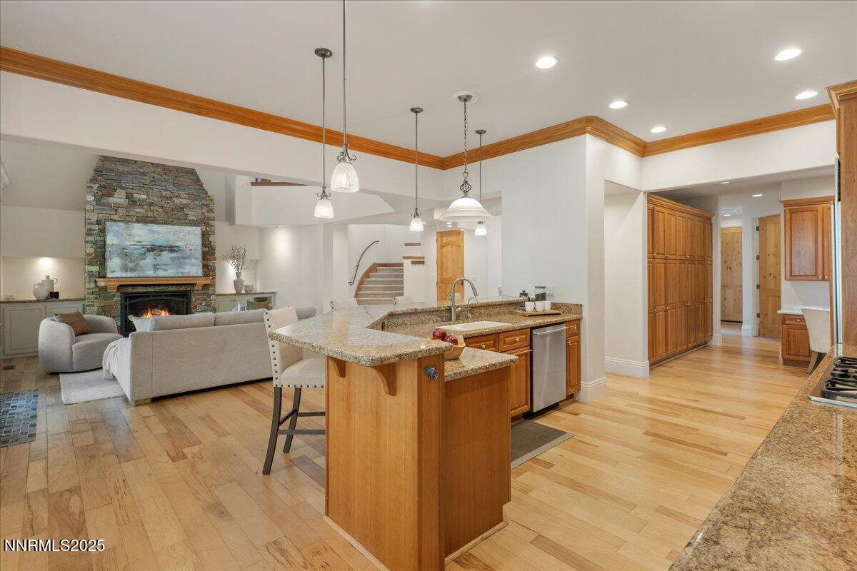 6410 Zermatt Court Reno, NV 89511 - Photo 15 of 52 a large living room with stainless steel appliances kitchen island granite countertop a large kitchen island a stove a sink a refrigerator and a living room view