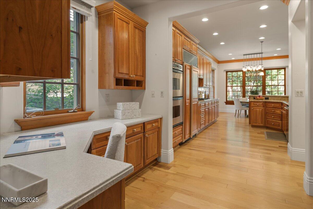 6410 Zermatt Court Reno, NV 89511 - Photo 16 of 52 a large kitchen with stainless steel appliances a large window and a counter top space