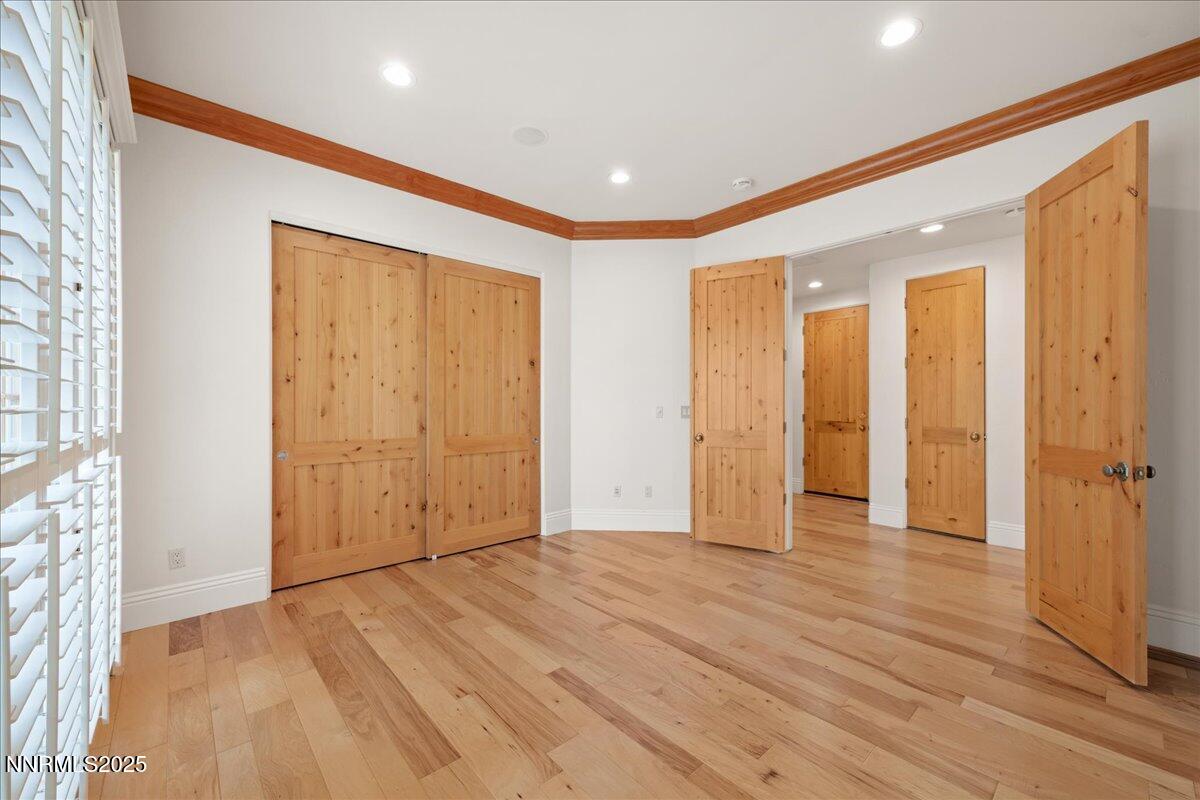 6410 Zermatt Court Reno, NV 89511 - Photo 24 of 52 an empty room with wooden floor and windows