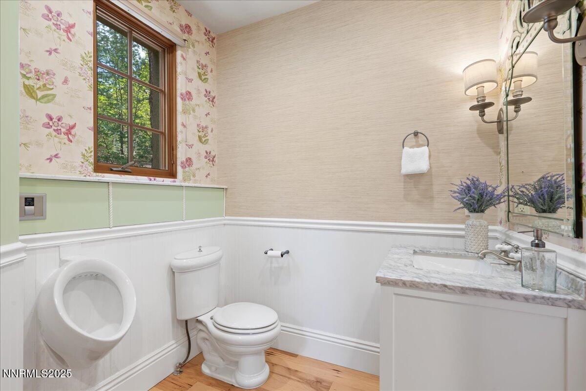 6410 Zermatt Court Reno, NV 89511 - Photo 26 of 52 a bathroom with a granite countertop toilet sink and mirror