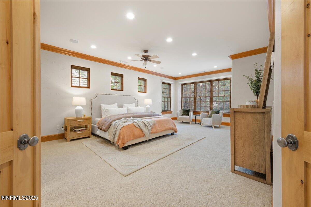 6410 Zermatt Court Reno, NV 89511 - Photo 29 of 52 a bedroom with a large bed and a chandelier