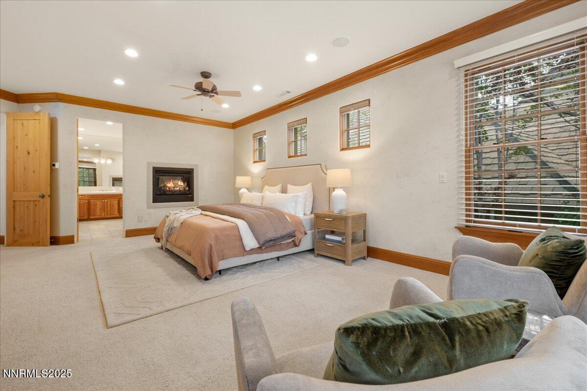 6410 Zermatt Court Reno, NV 89511 - Photo 32 of 52 a spacious bedroom with a bed a couch and cabinet