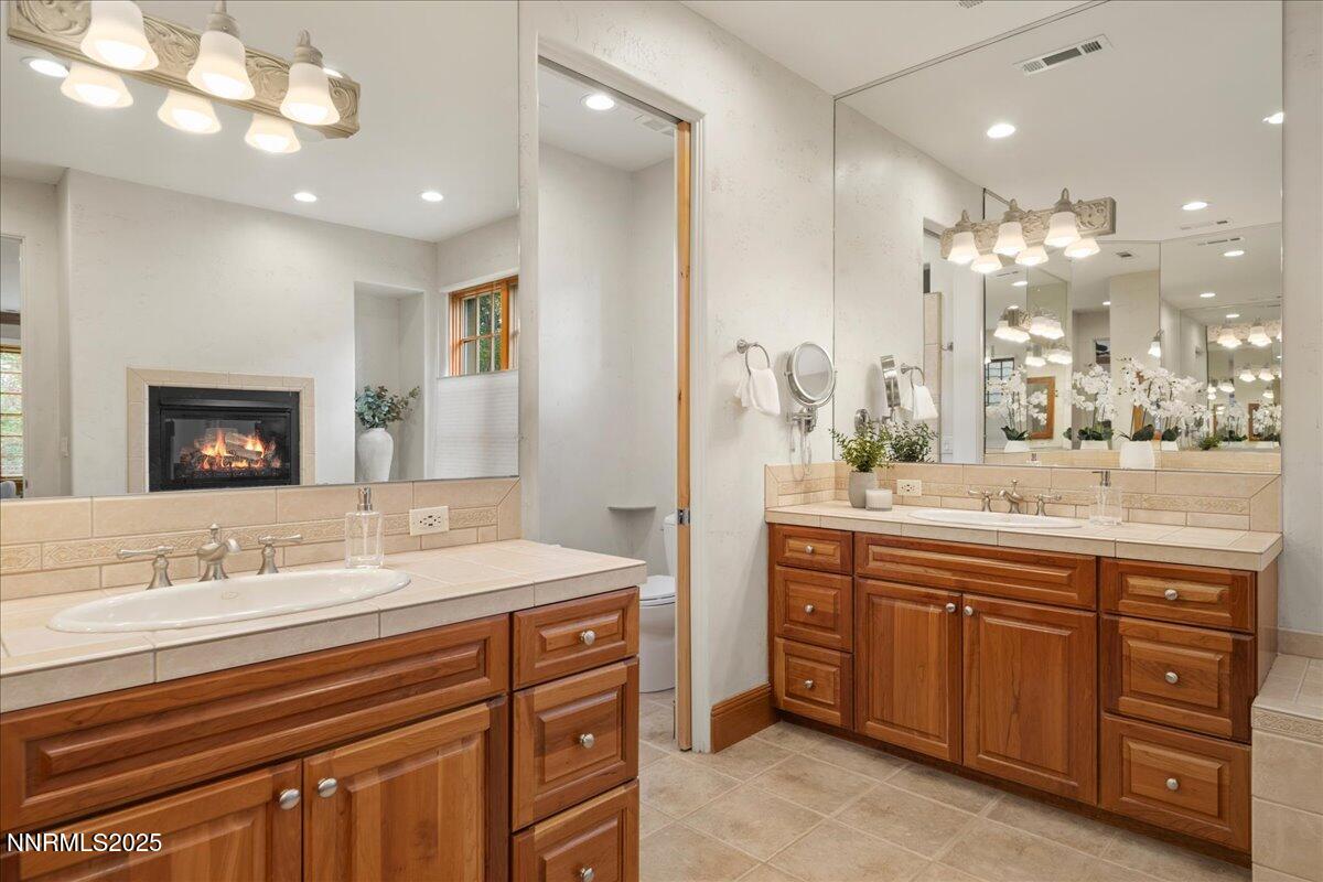 6410 Zermatt Court Reno, NV 89511 - Photo 38 of 52 a bathroom with a sink double vanity and a mirror