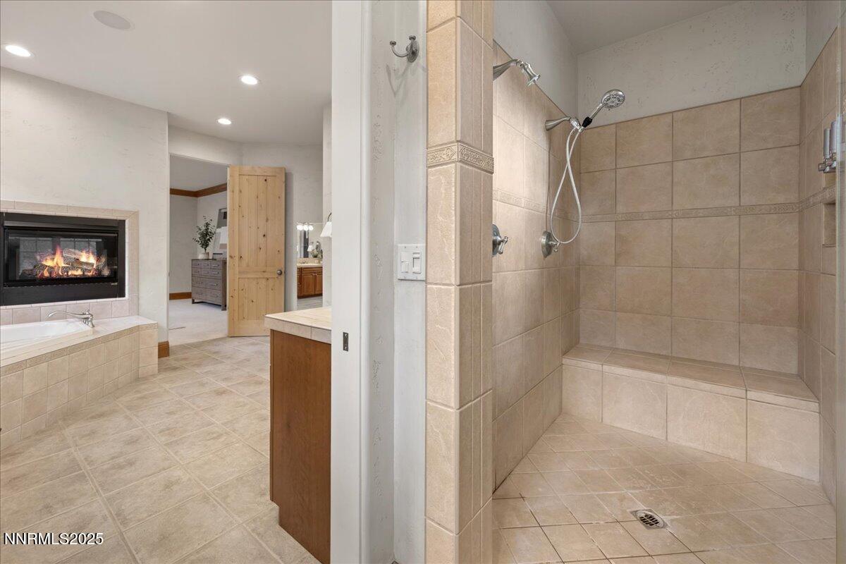 6410 Zermatt Court Reno, NV 89511 - Photo 39 of 52 a bathroom with a bathtub and a shower