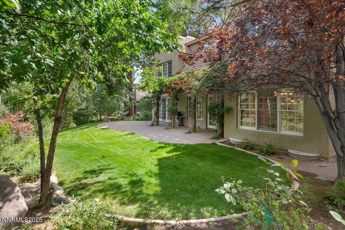 6410 Zermatt Court Reno, NV 89511 - Photo 48 of 52 a view of backyard with a garden and trees
