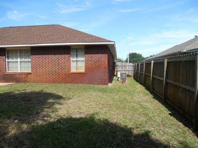 a kitchen with cabinets appliances and a window
