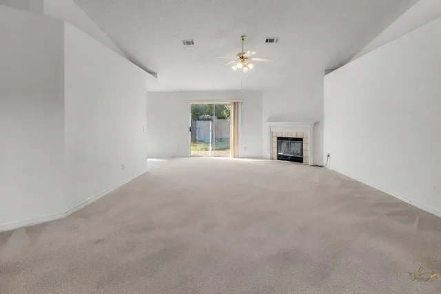 an empty room with closet and a chandelier fan