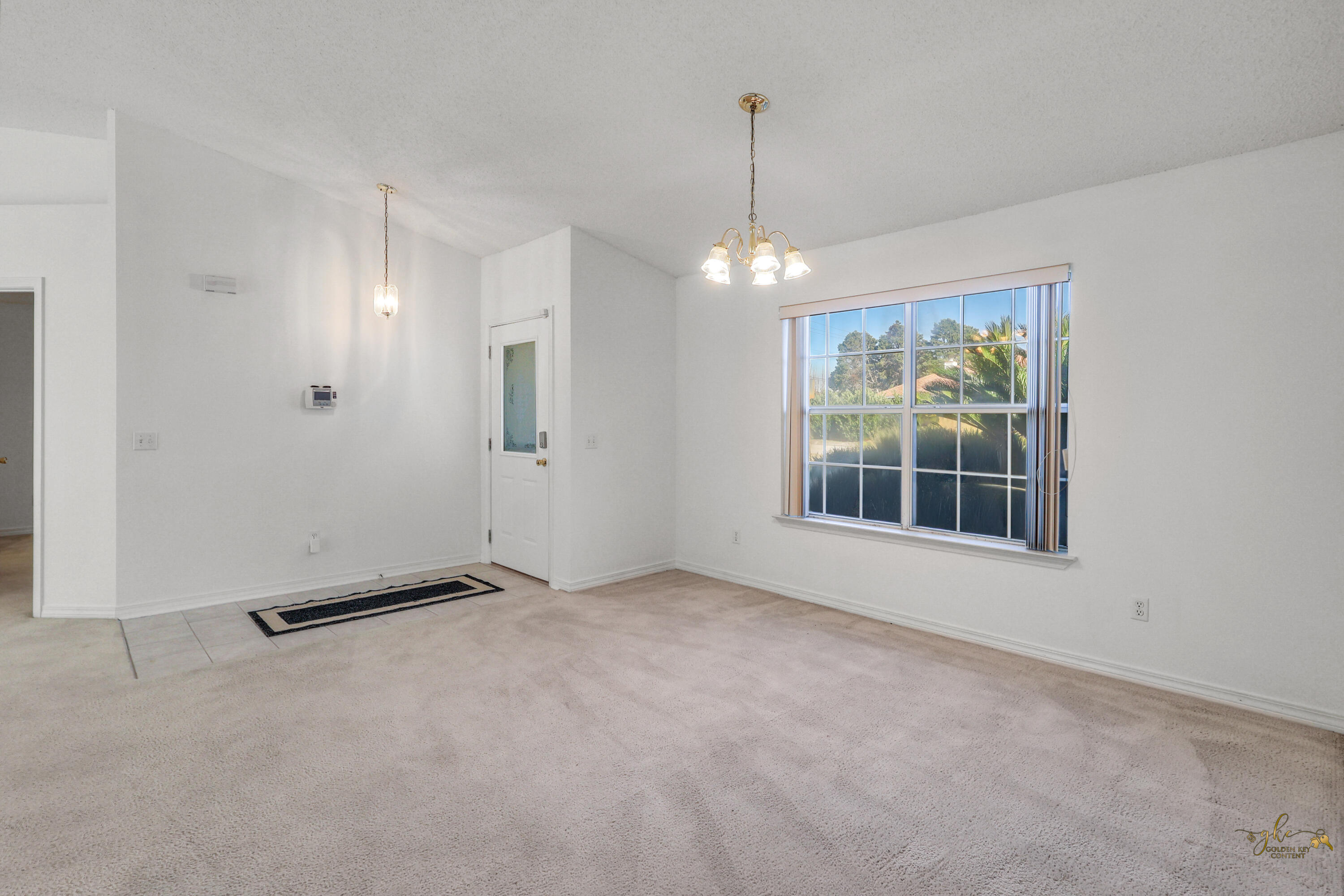 2095 Jessica Way Navarre, FL 32566 - Photo 16 of 52 a view of an empty room with window and chandelier fan