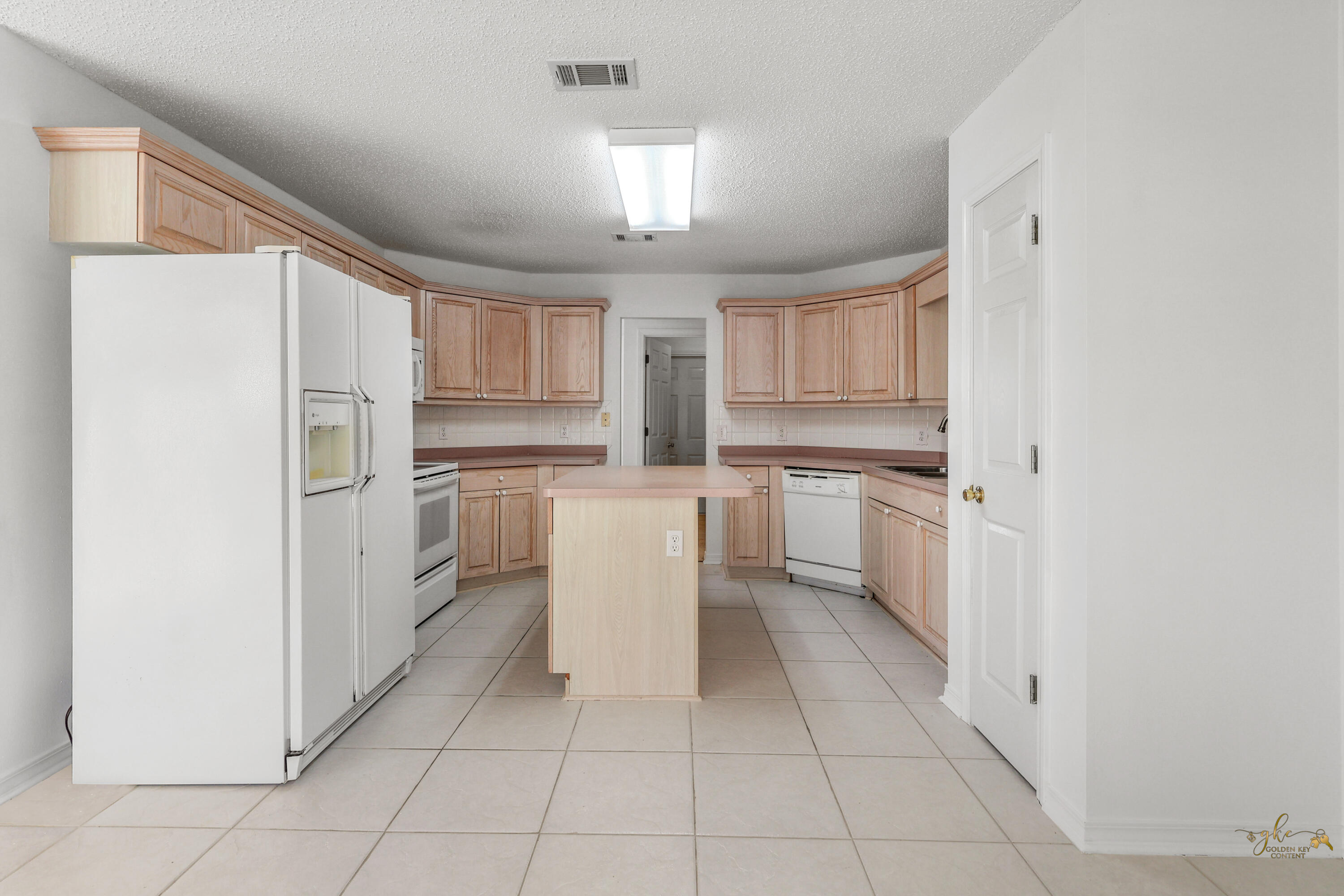 2095 Jessica Way Navarre, FL 32566 - Photo 22 of 52 a kitchen with white cabinets and white appliances