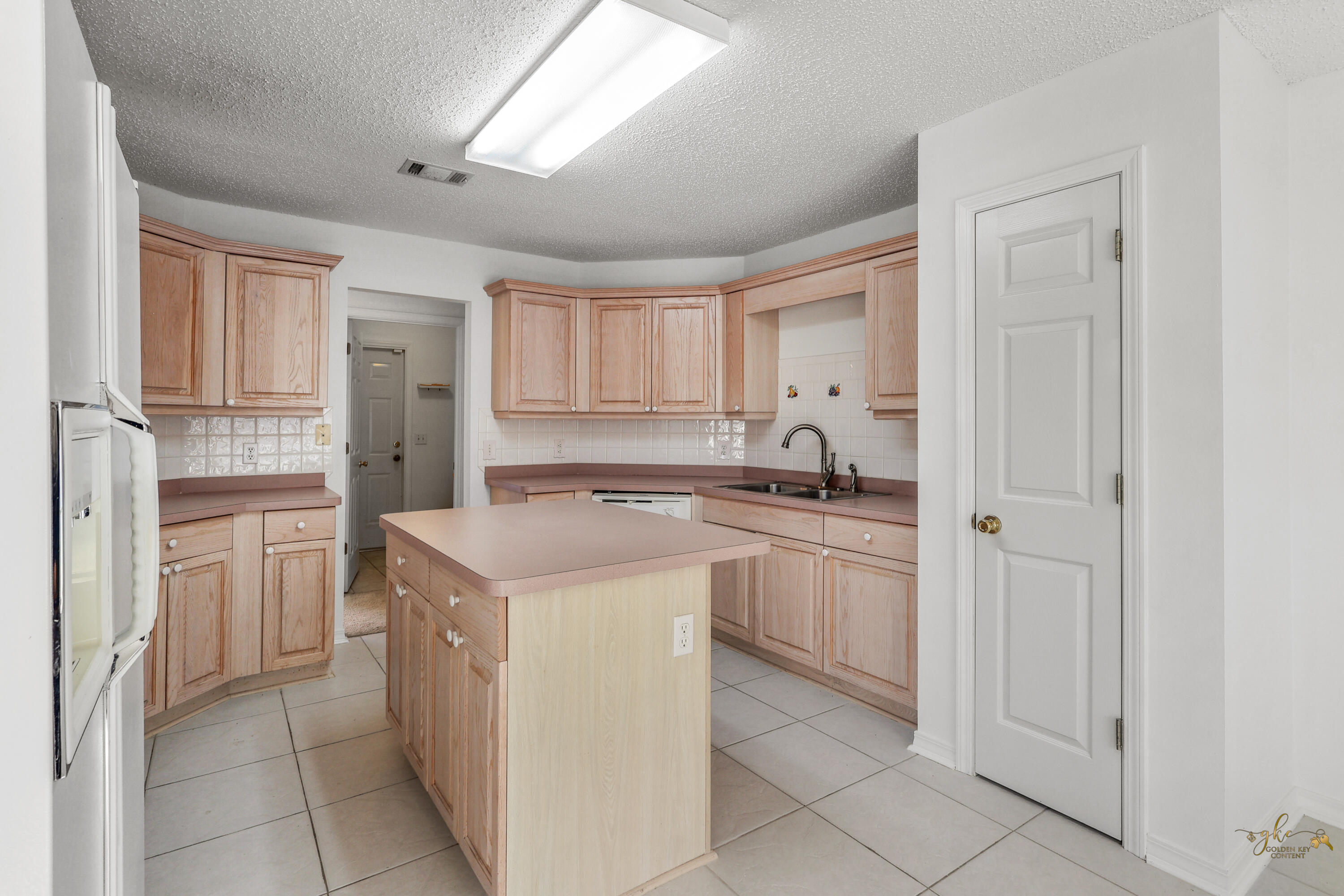 2095 Jessica Way Navarre, FL 32566 - Photo 24 of 52 a kitchen with a sink dishwasher a refrigerator and cabinets