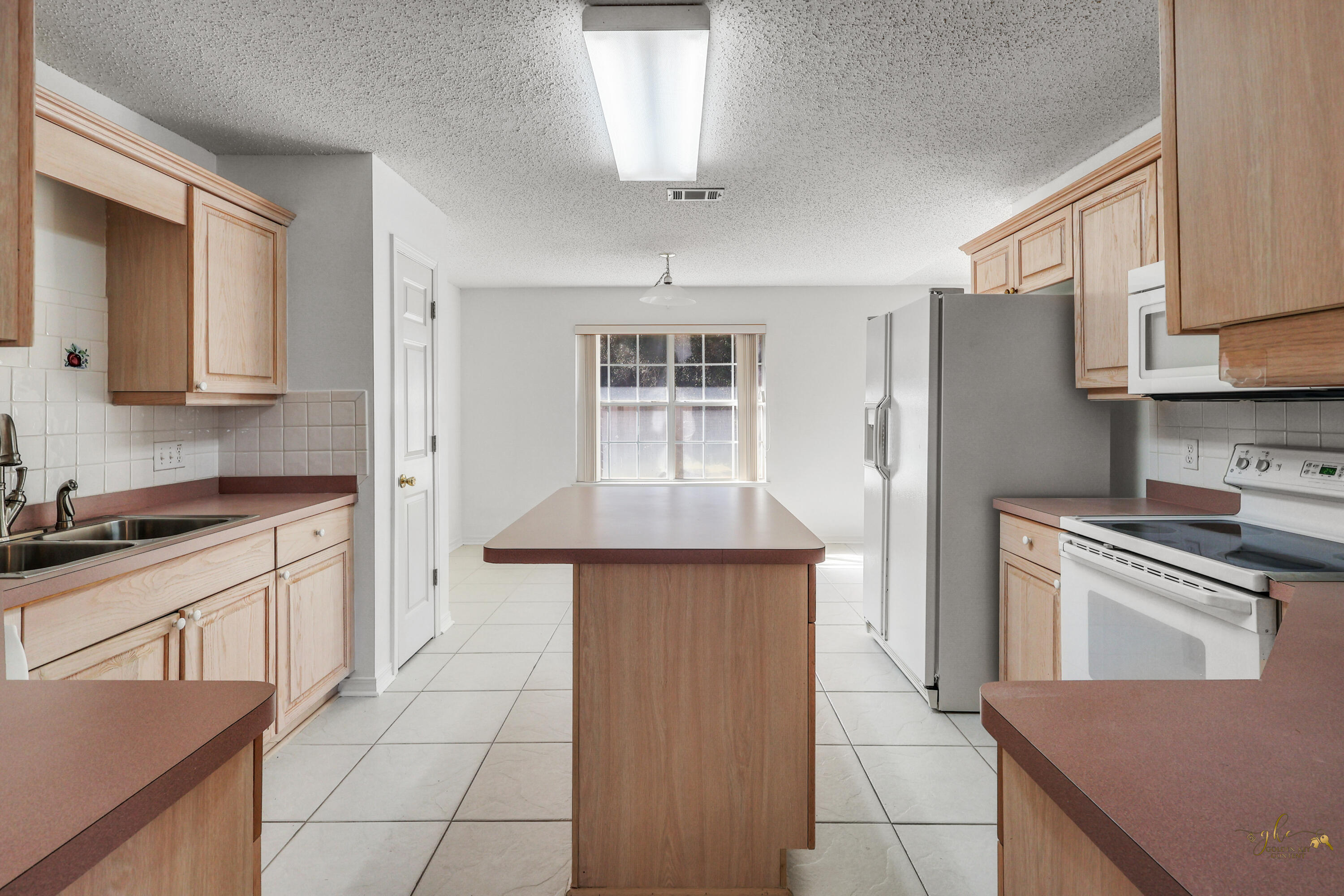 2095 Jessica Way Navarre, FL 32566 - Photo 9 of 52 a kitchen with stainless steel appliances granite countertop a stove a sink and a refrigerator