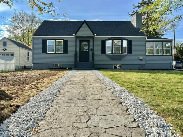 a front view of a house with a yard