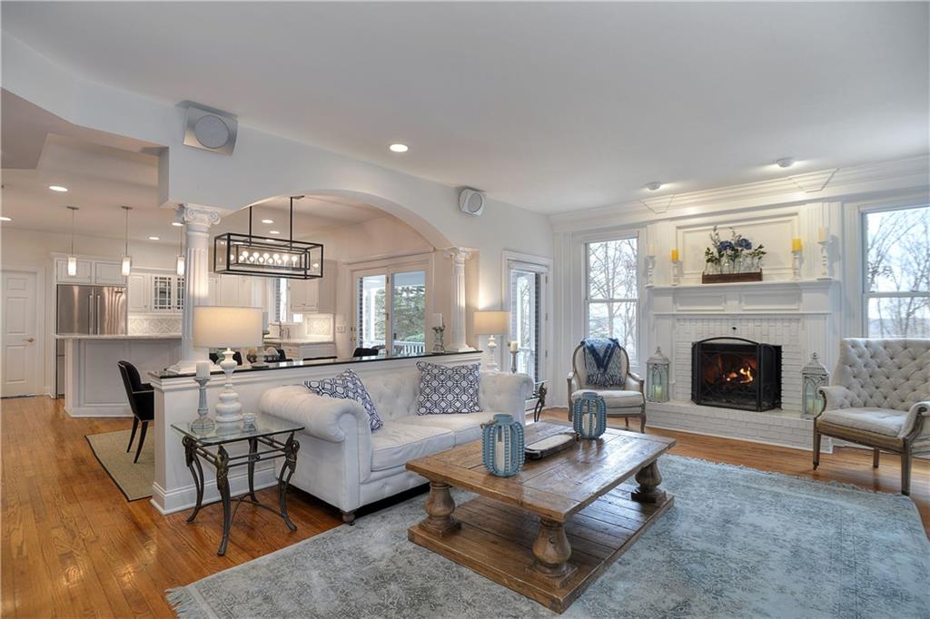 32 Newgate Road Pittsburgh, PA 15202 - Photo 3 of 25 Ideal for hosting friends and family, the open concept living/dining room has a fireplace and numerous large windows. An artful blend of classic period details and modern style.