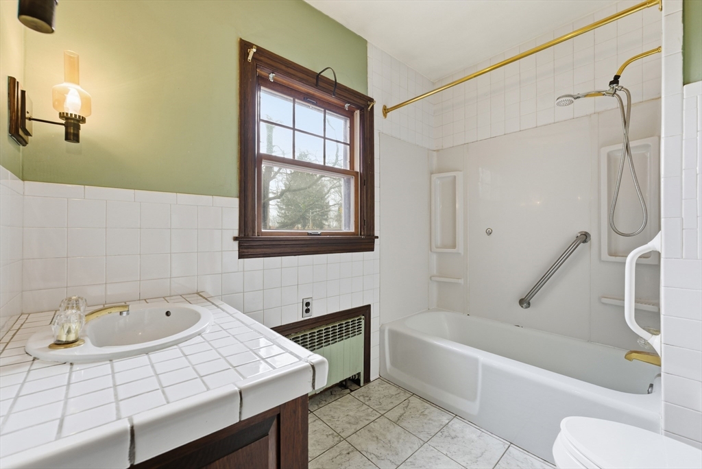 171 Maple Street East Longmeadow, MA 01028 - Photo 27 of 42 a bathroom with a tub a sink and a window