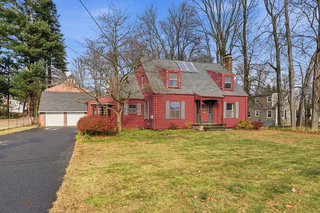 171 Maple Street East Longmeadow, MA 01028 - Photo 4 of 42 a view of a yard in front of a brick house with large windows