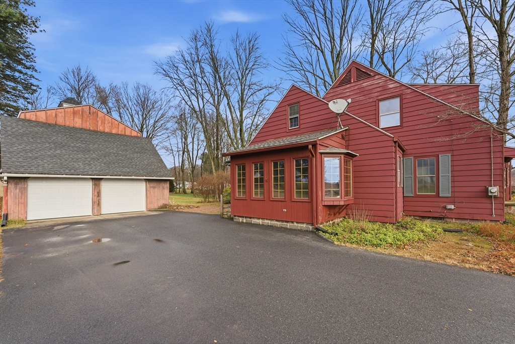 171 Maple Street East Longmeadow, MA 01028 - Photo 5 of 42 a front view of a house with a yard and garage