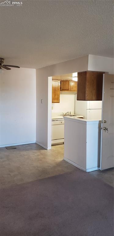 814 Tenderfoot Hill Road, Unit 102 Colorado Springs, CO 80906 - Photo 11 of 11 a view of a kitchen with a sink cabinets and a window